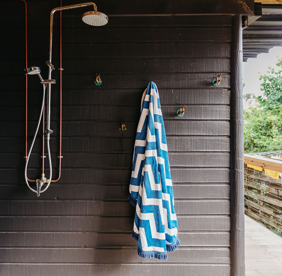 Photograph of an outdoor shower (with towel hanging)