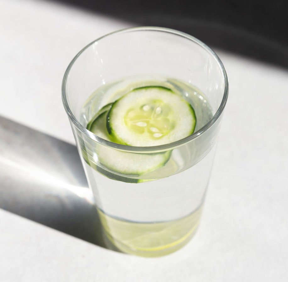 Closeup photograph of a glass of cucumber water