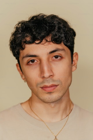 Customer with short curly hair and neutral expression